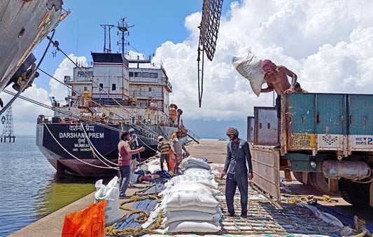 Labourers unload rice bags from a supply truck at India's main rice port at Kakinada Anchorage in the southern state of Andhra Pradesh.