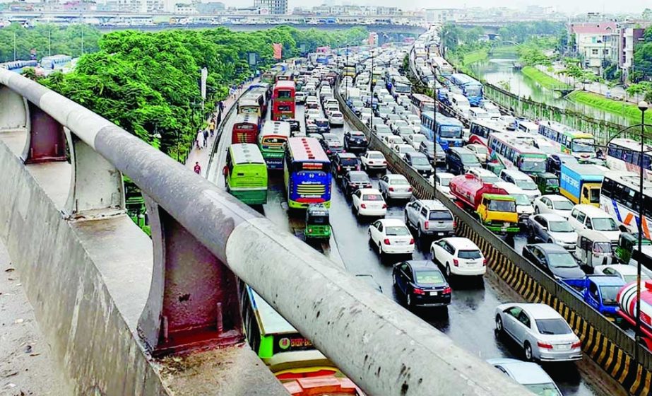 Traffic gets completely clogged on Airport Road in the capital on Tuesday, after rains lashed the city since morning under the influence of low pressure over the Bay of Bengal. NN photo