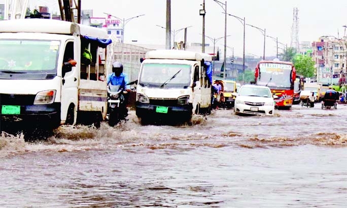 Vehicles ply through a waterlogged road in front of Kalshi area in the capital on Wednesday, as incessant rains lashed across the country due to depression over the Bay of Bengal.
