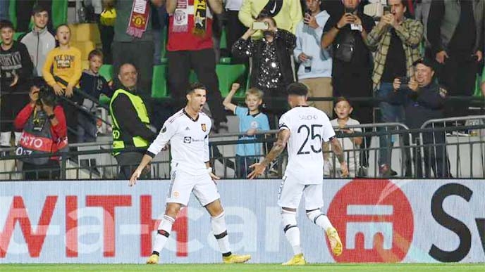 Manchester United's Portuguese striker Cristiano Ronaldo (left) celebrates with Jadon Sancho after scoring the second goal during their UEFA Europa League group E football match against Sheriff at Zimbru stadium in Chisinau of Moldova on Thursday.