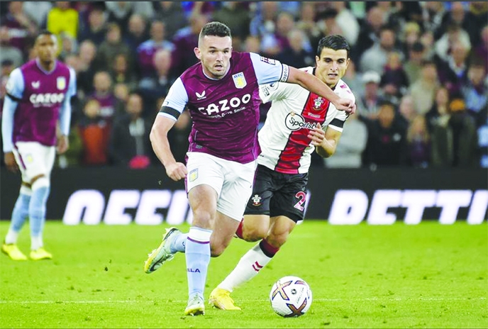 Aston Villa's John McGinn runs with the ball watched by Southampton's Mohamed Elyounoussi (right) during Villa and Southampton at Villa Park in Birmingham on England.