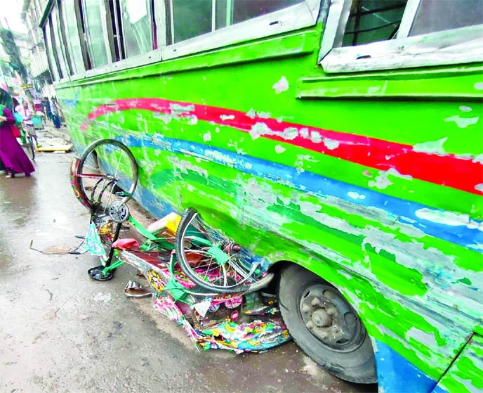 A rickshaw crushes under the wheels of a passenger bus in front of Jagannath University on Sunday leaving one dead on the spot and two others injured.