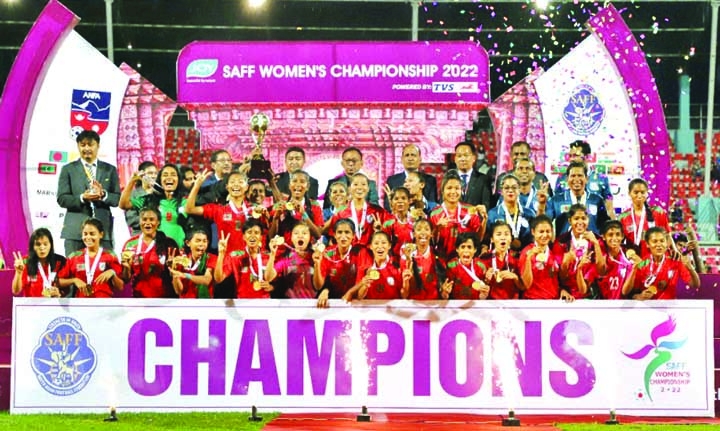 Bangladesh players celebrate with the trophy after defeating Nepal in the final of the SAFF Women's Football Championship at the Dasharath Rangasala Stadium in Kathmandu on Monday. NN photo