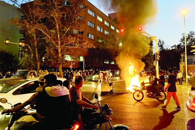 Demonstrators gathering around a burning barricade during a protest for Mahsa Amini, a woman who died after being arrested by the Islamic republic's 'morality police,' in Tehran on Wednesday.