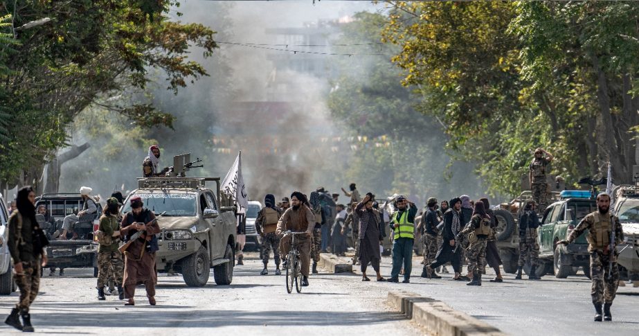 Taliban fighters stand guard at the explosion site, near a mosque, in Kabul, Afghanistan, Friday, Sept. 23, 2022.