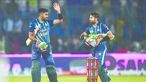 Pakistan's captain Babar Azam (left) and teammate Mohammad Rizwan celebrate after their win at the end of the second Twenty20 International cricket match between Pakistan and England at the National Cricket Stadium in Karachi on Thursday.