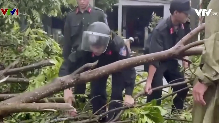 In an image taken from video, officials remove fallen trees from roads from Typhoon Noru, Wednesday, Sept. 28, 2022, in Quang Nam province, Vietnam.