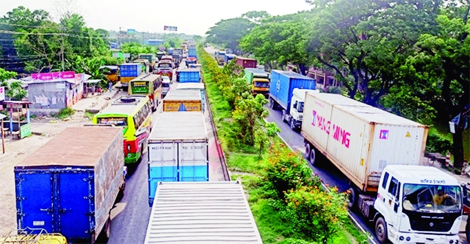 Hundreds of vehicles get clogged in 25 km long tailback due to road work of Dhaka-Cumilla Highway. This photo was taken on Wednesday.
