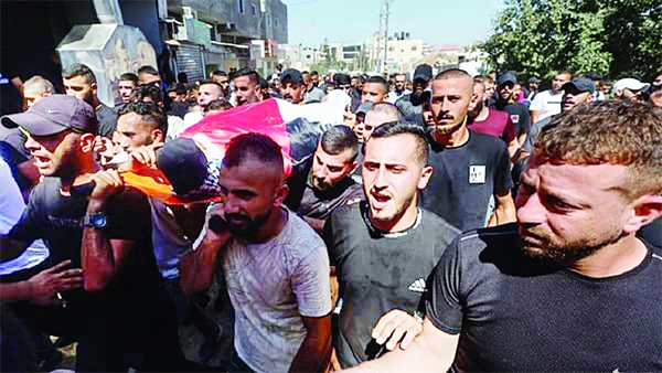 Mourners carry the body of Palestinian gunman Abdulrahman Khazem, who was killed by Israeli forces in a raid, during his funeral in Jenin in the Israeli-occupied West Bank on Wednesday.