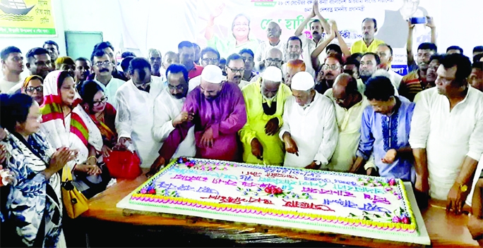 ISHWARDI (Pabna) : Alhaj Nuruzzaman Biswas MP cuts a cake marking the 76th birthday of Prime Minister Sheikh Hasina organized by Ishwardi Upazila Awami League on Wednesday.